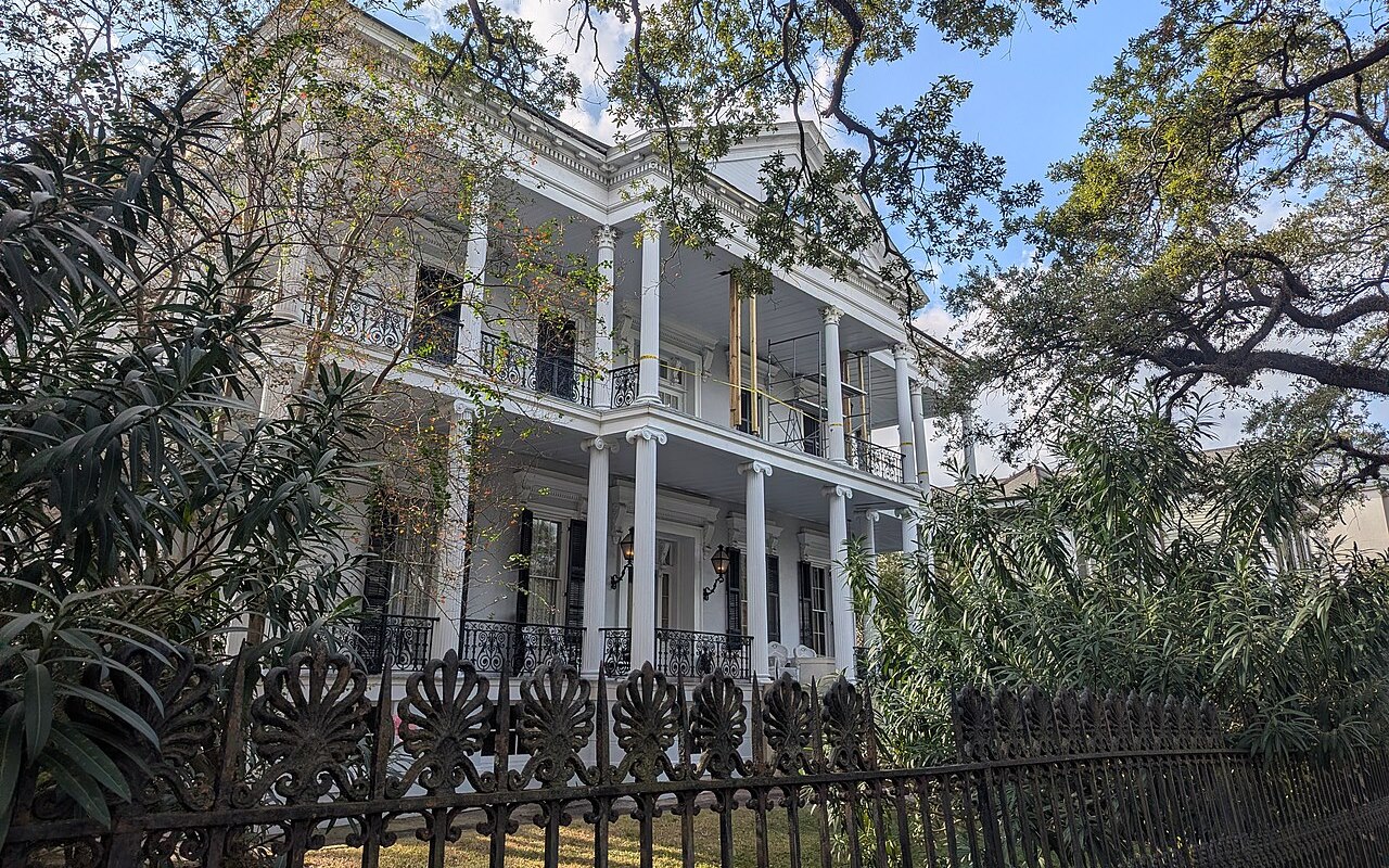 Buckner Mansion, a columned house behind an iron fence in New Orleans
